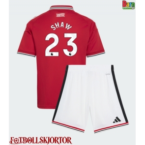 Manchester United Luke Shaw #23 Hemmakläder Barn 2026-27 Kortärmad (+ Korta byxor)